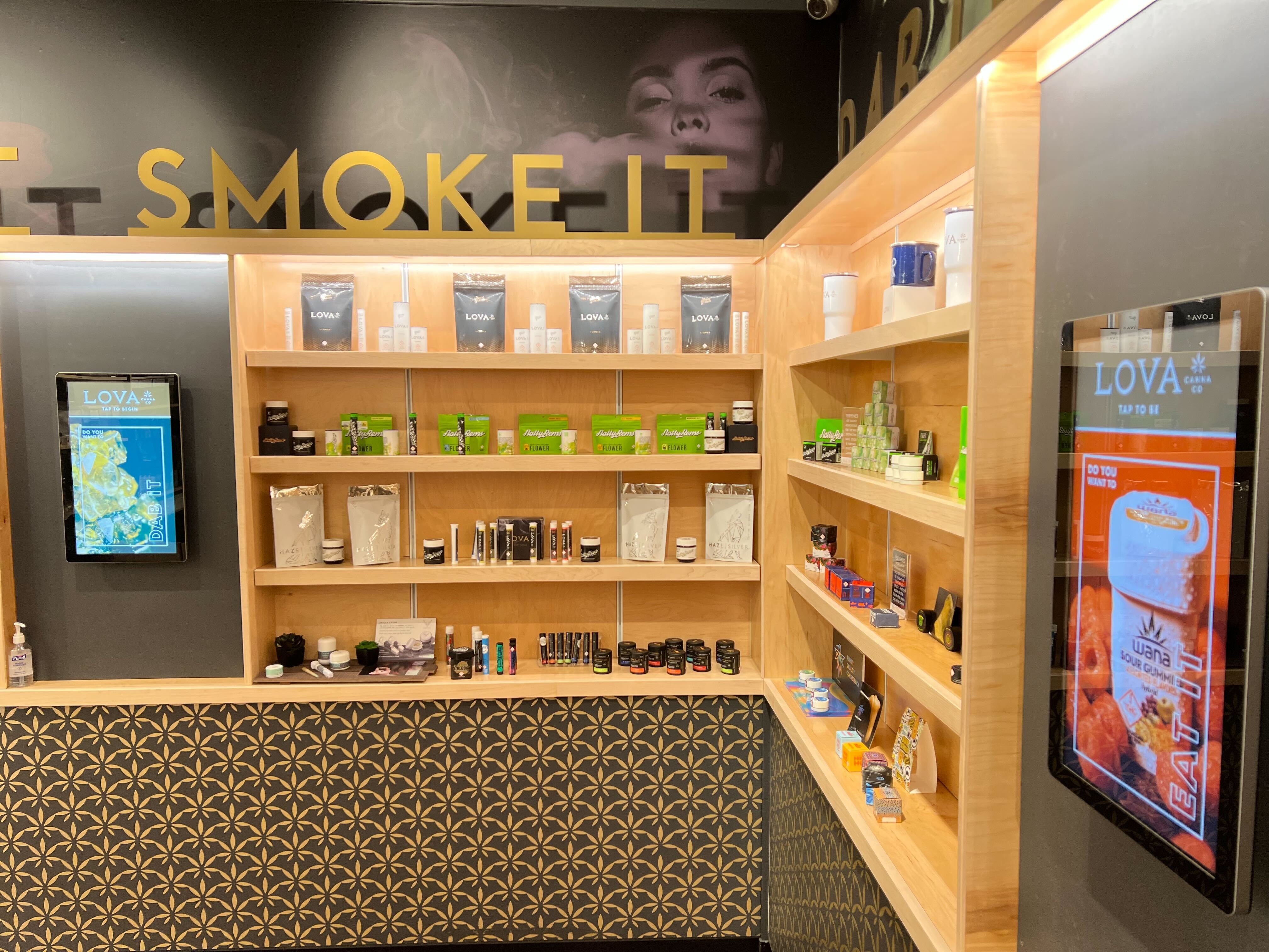 wall-mounted touchscreen dispensary kiosks at Lova in Colorado