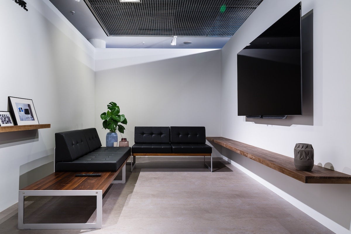 a clean, simple dispensary waiting room with prominent TV